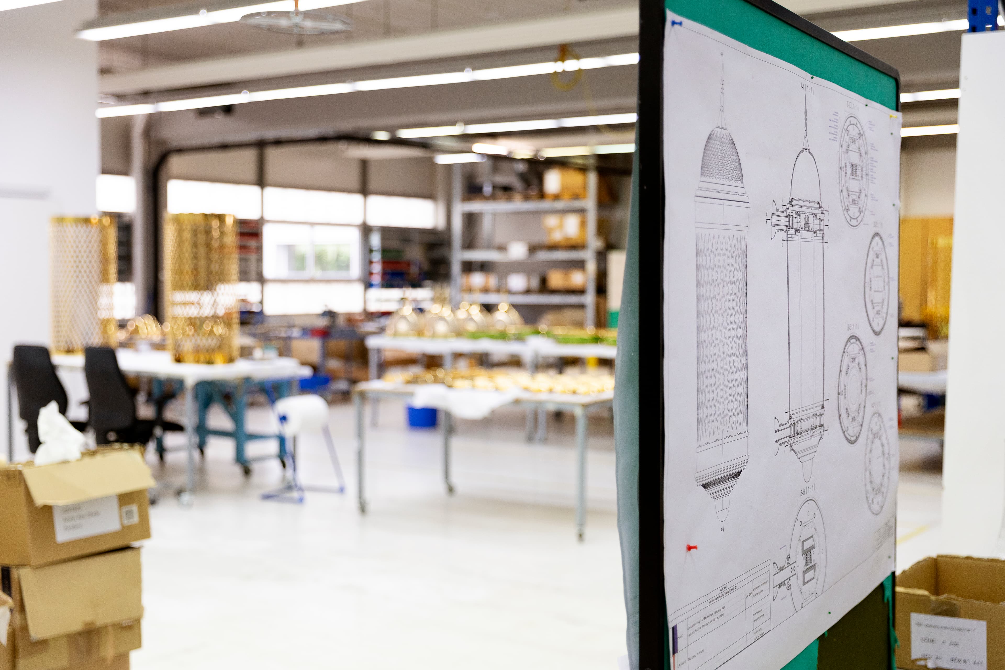 Large geometricceiling light installation with a glowing cracked-glass pattern, mounted within a metal truss structure at an event.